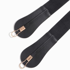 Detail of black elastic belt featuring high-quality leather stitch and gold metal hook buckle