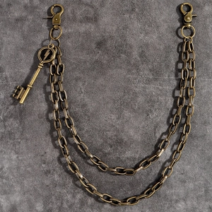 Detailed view of double-layered bronze wallet chain with lightning bolt key charm