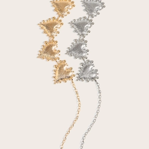 Detail showing heart-shaped metal waist chains in gold and silver with textured finish