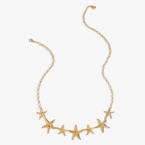 Detail view of gold starfish belly chain with textured pendants and lobster clasp closure