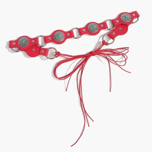 Close-up of bohemian red leather belt with turquoise inlay and silver metal rings