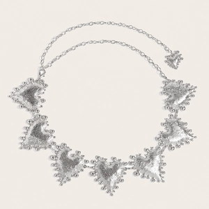 Detailed view of silver heart charms with lava texture and beaded edges on metal waist chain