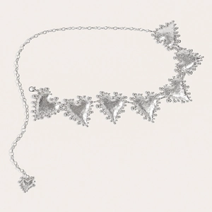 Detail of silver heart waist chain with hammered texture and vintage metal links