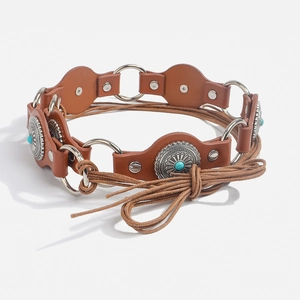 Detail of bohemian leather belt with turquoise inlay and vintage silver metal rings