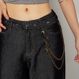 Detail of vintage gold punk waist chain with double layers and feather wing charm pendant