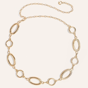 Detail of golden metal waist chain featuring large oval links and adjustable lobster clasp