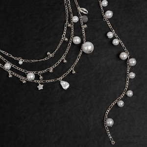 Detailed close-up of Bohemian Y2K metal waist chain with pearls and star shell pendants