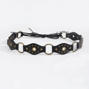 Detail of black leather belt with metal studs and bronze rings for bohemian style look
