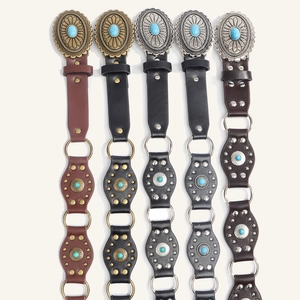 Detail of western cowgirl belts featuring vintage turquoise buckles and metal rivets