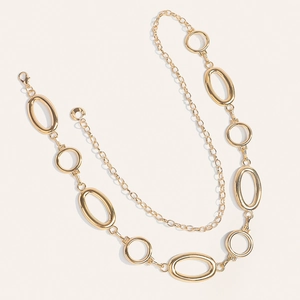 Detail of gold metal waist chain with elegant oval links and lobster clasp closure