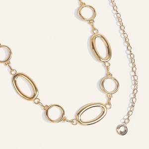 Macro shot of stylish gold round chain belt with large metallic oval links for dresses