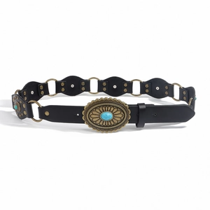 Detail of western cowgirl belt with turquoise buckle and bronze linked metal rings