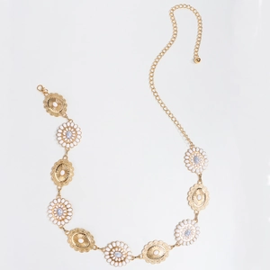 Detail of bohemian gold waist chain with white floral accents and adjustable lobster clasp