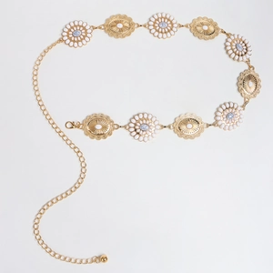 Close-up of bohemian gold flower chain belt with white gemstones and blue marble beads