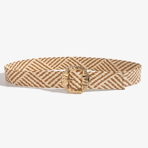 Detail of bohemian woven belt with decorative gold rectangular buckle and straw texture
