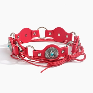 Vintage punk leather belt with turquoise concho and silver metal rings on white background