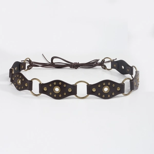Detail view of retro braided waist belt with brown oval patches and brass metal rings