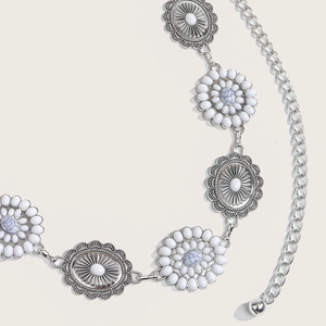 Detail of silver bohemian metal waist chain with white stone inlay and vintage engraving