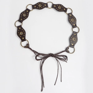 Close-up of vintage brown leather waist chain with bronze rings and metal rivets detail