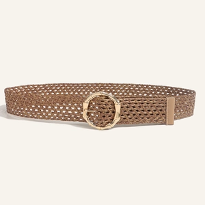 Close-up of brown woven bohemian belt with a round gold buckle and bamboo texture