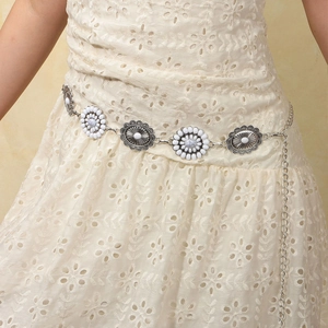 Detail view of a bohemian silver metal waist chain with white floral turquoise inlays