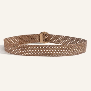 Close-up of brown woven bohemian waist belt with a golden geometric buckle detail