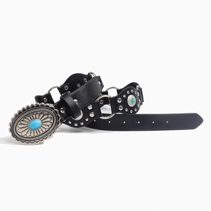 Detail of western leather belt featuring turquoise buckle and vintage silver metal studs