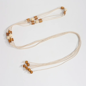Nahaufnahme der geflochtenen Bohemian-Taillenkette mit Vintage-Holzperlen und Quasten