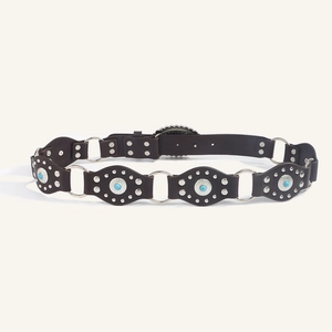 Detailed macro view of western belt with turquoise studs and vintage silver ring connectors