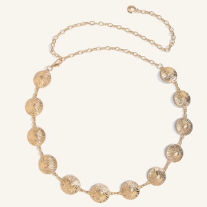 Detail of golden metal waist chain with embossed circular plates and adjustable clasp