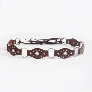 Detail of vintage punk belt featuring brown leather diamonds with silver metal rings