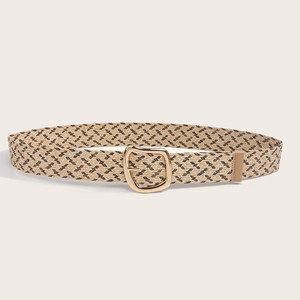 Detail of bohemian straw woven belt featuring khaki herringbone pattern and gold D-ring buckle