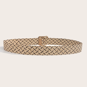 Detail of woven bohemian belt with golden buckle and textured wavy pattern in earthy tones
