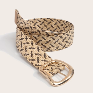Detail of bohemian straw woven belt with dual-tone herringbone pattern and gold buckle