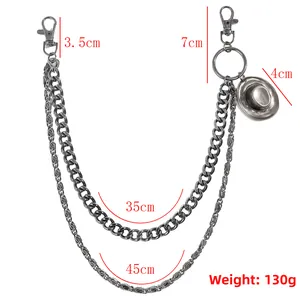Detail of multi-layered punk style pants chain with bronze cowboy hat pendant