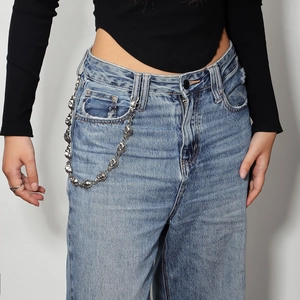 Punk style waist chain with 3D metal skulls on light blue vintage washed denim jeans