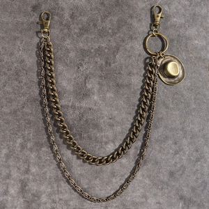 Detail of vintage bronze pant chain featuring a cowboy hat pendant and lobster clasps