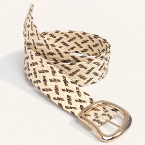 Detail of woven straw belt in beige and brown with a polished light gold round buckle