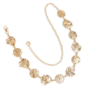Detailed macro view of golden hammered metal chain belt with adjustable lobster clasp