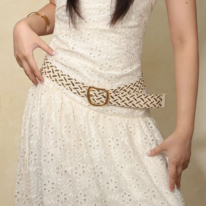 Bohemian woven straw belt with gold metal buckle paired on a white lace dress