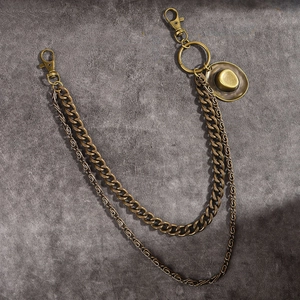 Detail of vintage bronze multi-layered wallet chain with a mini cowboy hat pendant