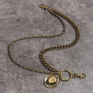 Detail of bronze retro punk waist chain featuring a cowboy hat pendant and dual links