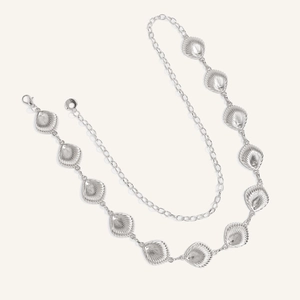 Detailed close-up of silver starfish shell chain with intricate textures and lobster clasp