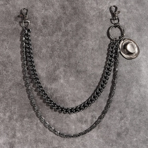 Detail of vintage bronze double layer pant chain with punk style straw hat pendant and clasps