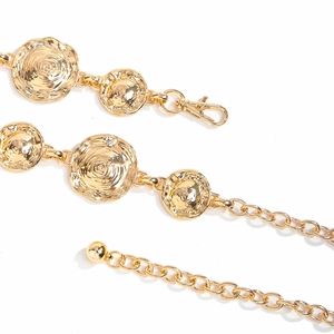 Detail of western vintage gold metal waist chain with hammered texture discs and lobster clasp