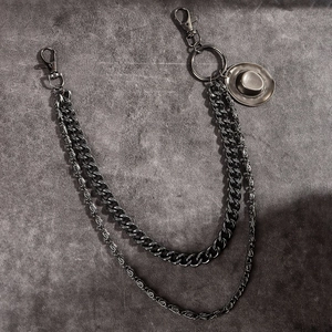 Detail view of retro bronze cowboy hat pendant on punk style double layered metal waist chain