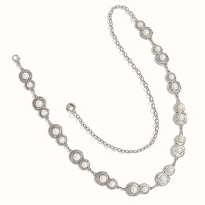 Close-up of vintage silver chain with round metal charms and elegant white pearls