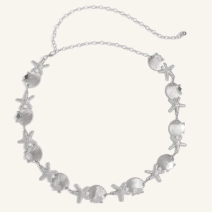 Detail of silver bohemian waist chain with starfish, shell charms and white pearls