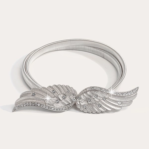 Detail of silver elastic spring belt with rhinestone angel wings buckle for dresses