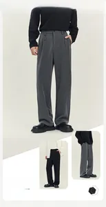 Dettaglio dei pantaloni uomo dritti e larghi in grigio scuro e nero dal tessuto fluido